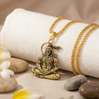 Lord Hanuman Golden Pendant With Chain with a warrior figure on a white fabric.