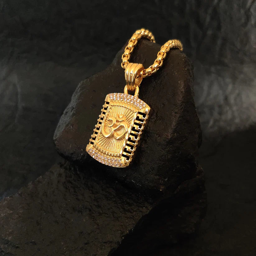 Gold pendant necklace on a dark stone surface