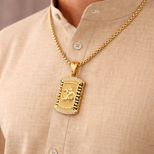 Gold necklace with a pendant on a beige shirt
